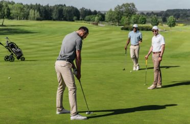 young-friends-playing-golf-together-on-green-at-daytime.jpg